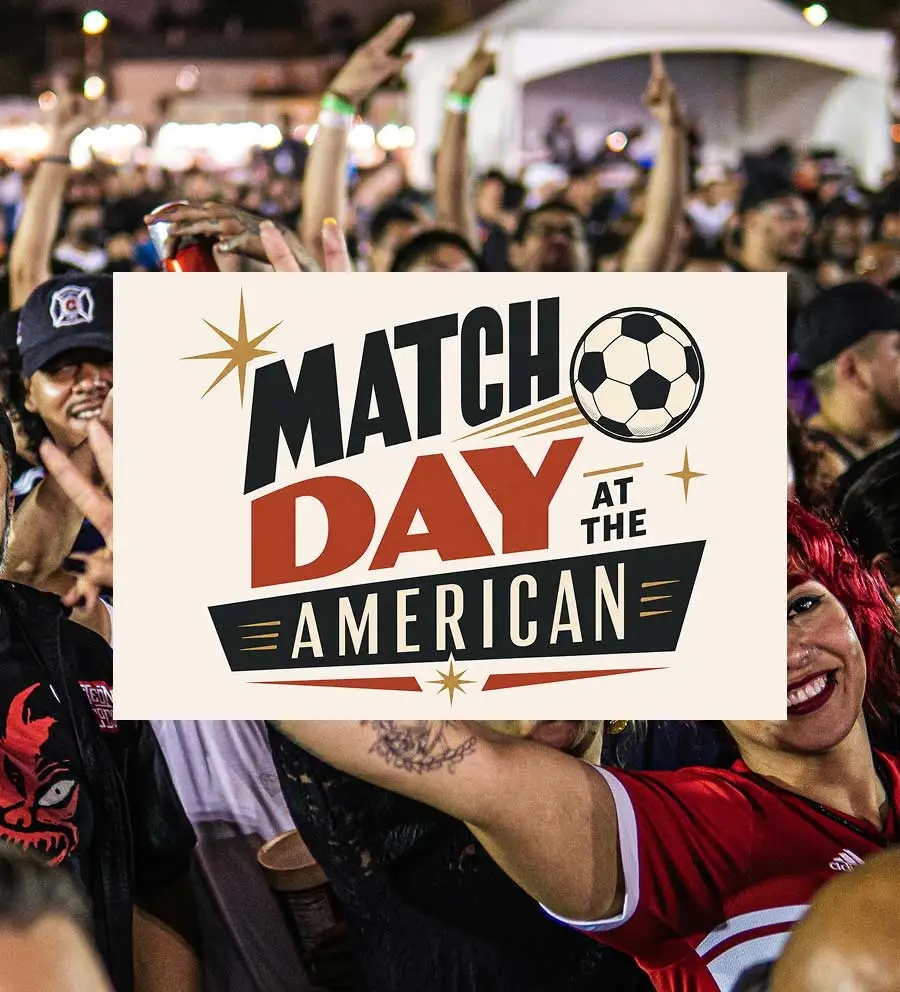 sign that says Match Day at the American Hotel with a crowd of soccer fans behind it
